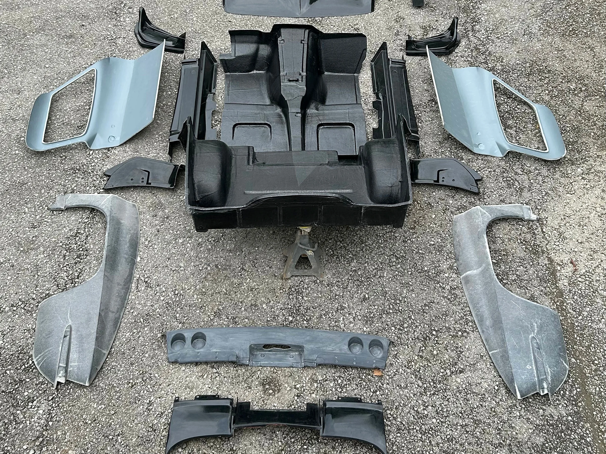 Corvette body panels and structural components arranged around a central composite tub.