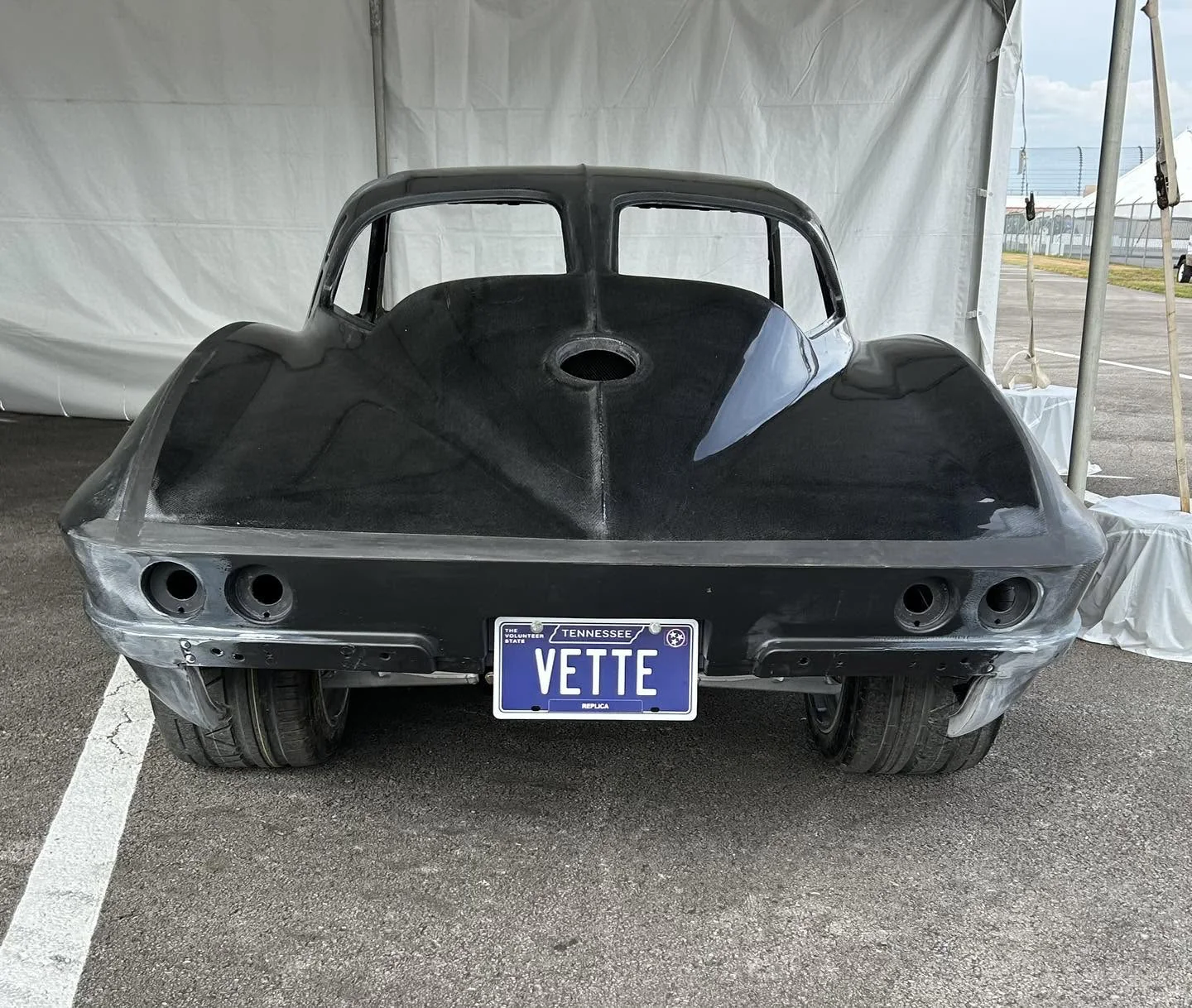 Bare carbon-composite C2 Corvette rear fastback with Tennessee VETTE license plate.
