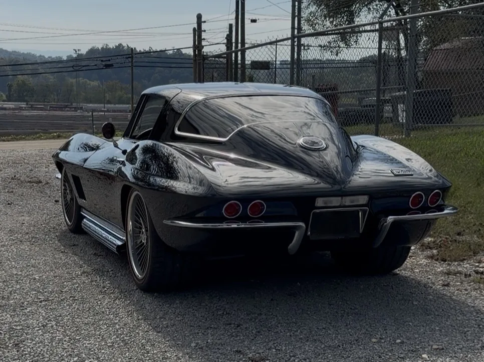 Dark Corvette rear view.