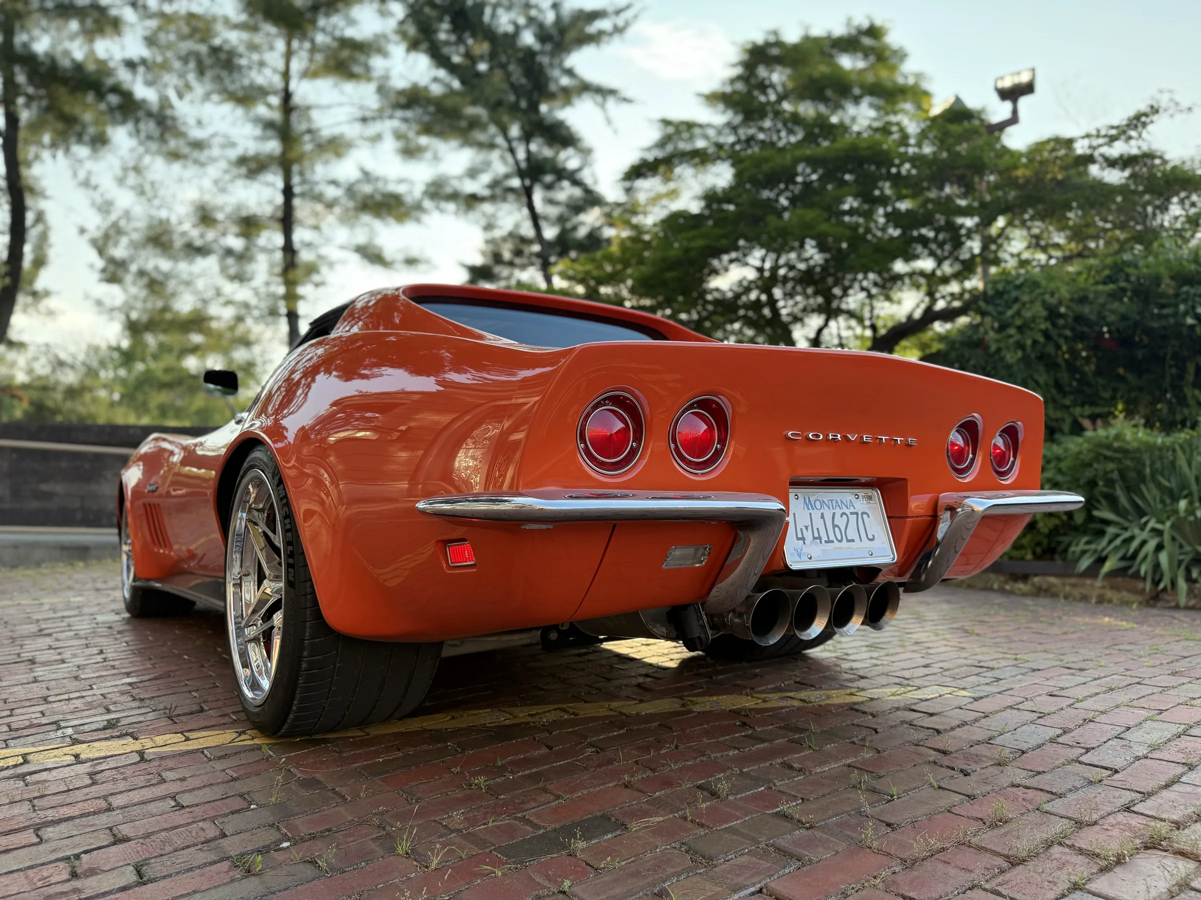 Rear detail view of the orange classic Corvette.